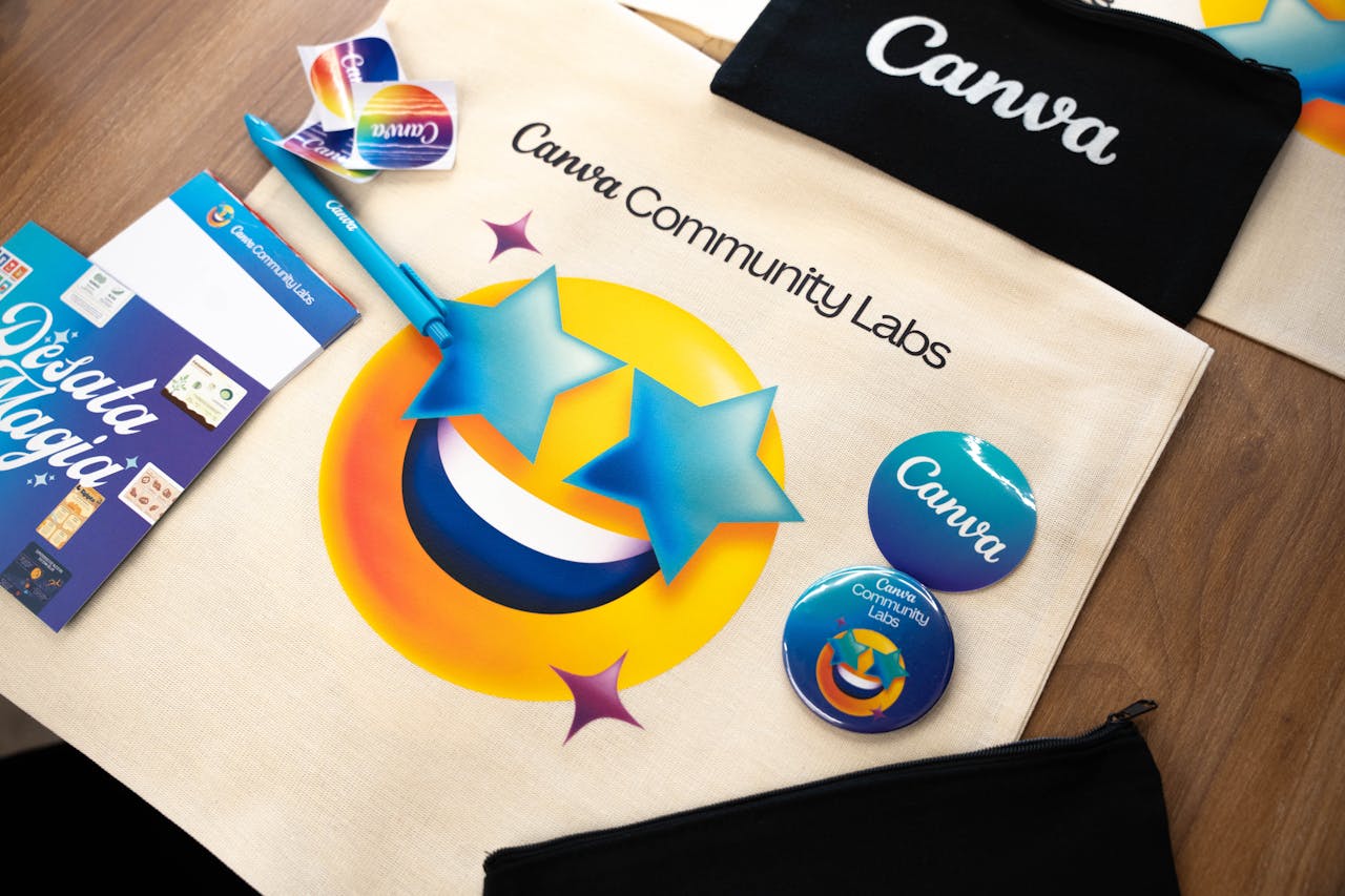 A vibrant display of Canva Community Labs tote, badges, and stationery.