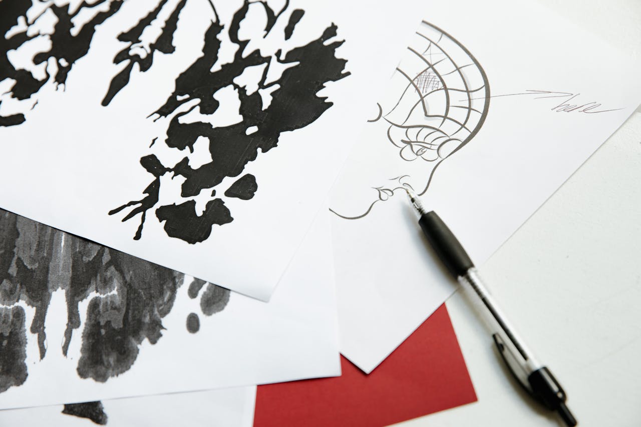 Black and white abstract ink drawings on paper with pen, showcasing artistic creativity.